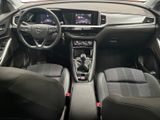 the interior of a car with a steering wheel, dashboard, and dashboard controls