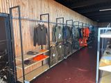 a room filled with lots of clothes and jackets on display