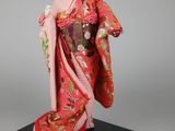 a figurine of a woman in a red kimono
