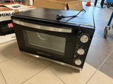 a black toaster oven sitting on the floor in a store