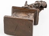 a statue of a man laying down on a bench