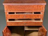 an image of a wooden chest of drawers with two doors open