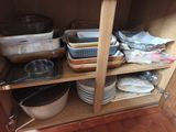 many dishes and pans on the shelves in the kitchen