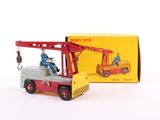 a toy truck with a man on it and a box behind it