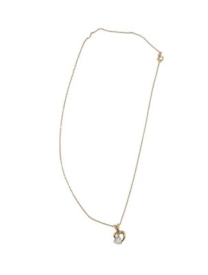a white and gold necklace with a heart pendant on a chain