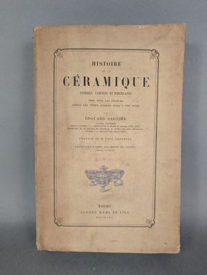 an old book sitting on top of a table next to a gray wall