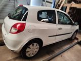 a picture of a small white car parked in a garage