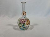 a small glass vase with a floral design on it