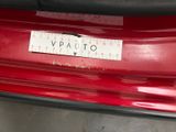 a close up of a sticker on the back of a red car