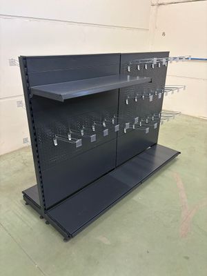 a close up of a metal shelf in a warehouse with lots of hooks