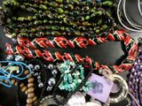 many different colored beads and bracelets on a table
