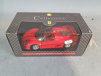 boxed box with a red toy car in it on a white surface