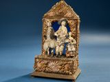 a figurine of a man and two children on a bench