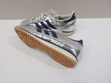 silver and blue adidas sneakers on a white surface
