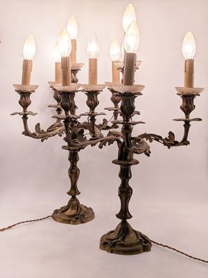 an image of a chandelier with five candles and a bird on it