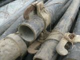 many pipes that are stacked together on the ground