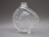 a clear glass bottle with a picture of a man and a woman on it