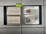a binder with three pages on it on a tiled wall