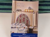 a picture of a book on a table next to a pillow