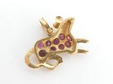 yellow gold giraffe charm with ruby eyes on a white background