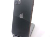 a black iphone sitting on a stand on a white surface