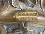 a close up of a metal object with a clock on it