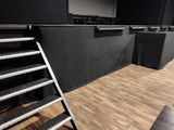a room with a lot of chairs and ladders in it