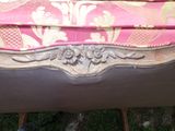 a bench with a pink and gold upholstered seat