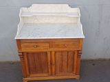 a wooden cabinet with a marble top on the street