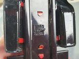 a person holding a black and red model of a vespa