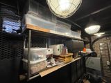 a room with a lot of clutter and boxes on the shelves
