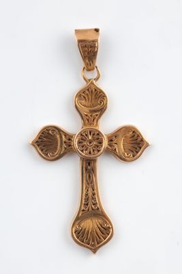 a gold cross pendant with a flower design on it