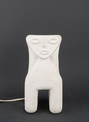 a white ceramic sculpture of a woman ' s face on a black background