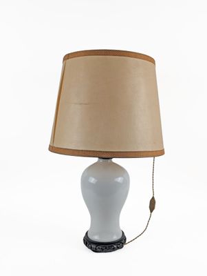 a white table lamp with a brown shade on it