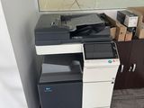 a printer sitting on top of a cabinet in a room