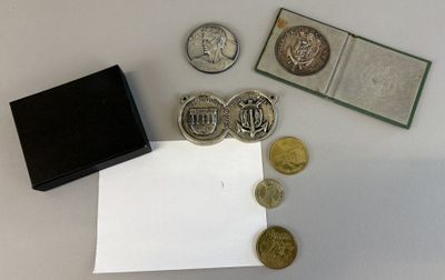 a small box of coins and a small box of coins on a table