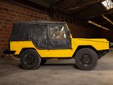 a yellow jeep with a black top parked in a garage
