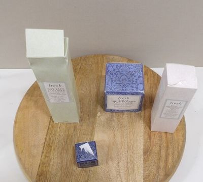 un plateau en bois sur lequel sont posées trois flacons de parfum