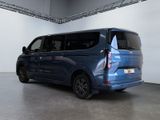 the rear end of a blue minivan parked in a garage