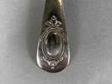 silver spoon with a picture of a woman in a frame on it