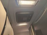 a view of the inside of an airplane with the lights on