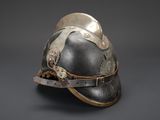 an old helmet with a metal buckle on the side of it