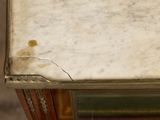 a close up of a marble top table with a glass top