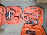 two orange cases with tools in them sitting on the floor