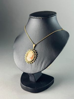 a close up of a necklace on a mannequin on a table