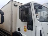 two white trucks parked next to each other in a parking lot