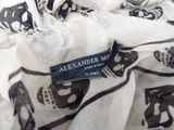 a close up of a black and white scarf with elephants on it