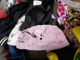 a pile of clothes that is sitting on top of a suitcase