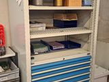a blue and white cabinet in the corner of a room