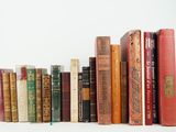 many books that are lined up on a shelf